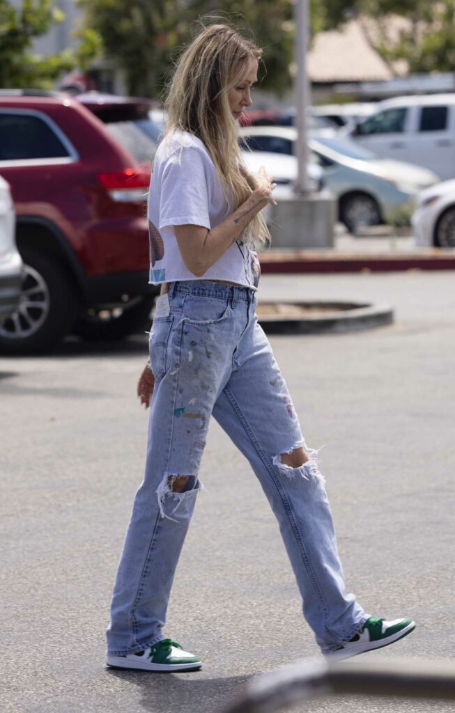 Tish Cyrus in a Ripped Jeans