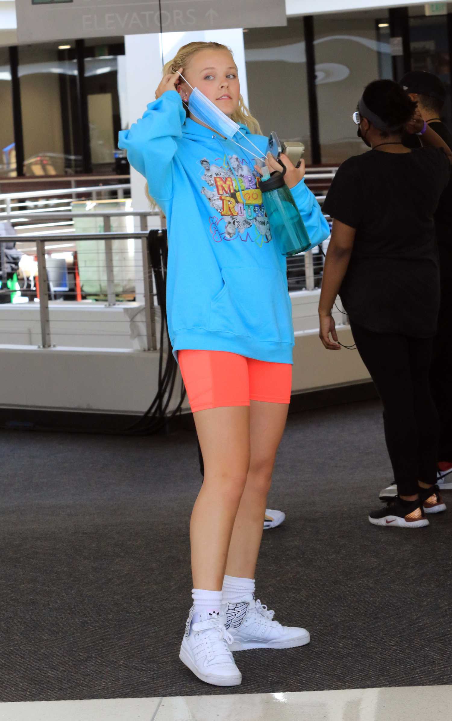 JoJo Siwa in a Baby Blue Hoodie Arrives at the Filming for America’s