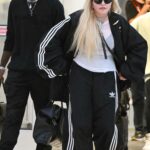 Madonna in a Black Adidas Tracksuit Arrives with Her Son David Banda at JFK Airport in New York