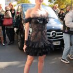 Kiernan Shipka in a Black Dress Arrives at the Giambattista Valli Show During 2022 Paris Fashion Week in Paris