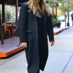 Margot Robbie in a Black Coat Arrives at Her Hotel in New York