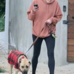 Anna Osceola in a Black Sneakers Walks Her Dog Near Her Home in Los Angeles