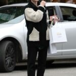 Emma Roberts in a Black Pants Enjoys Some Solo Christmas Shopping Around Melrose Place in Los Angeles