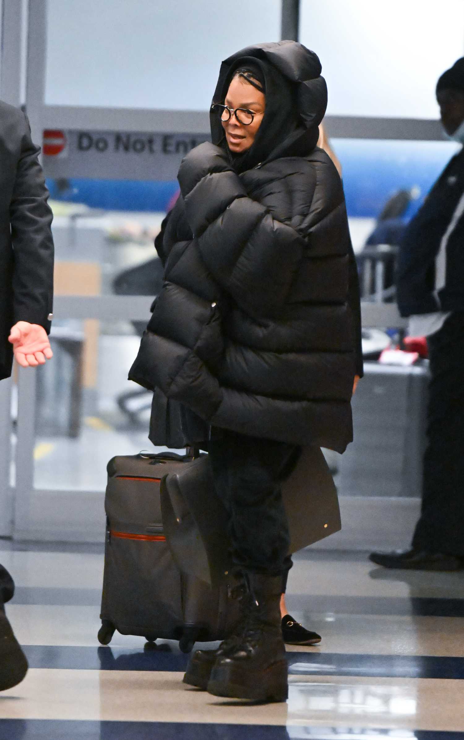 Janet Jackson in a Black Oversized Puffer Jacket Arrives at JFK Airport