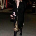 Kiernan Shipka in a Black Coat Arrives at Leonardo DiCaprio’s Holiday Party at Catch Steak in West Hollywood