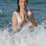 Maya Hawke in a White Swimsuit on the Beach in St. Barths