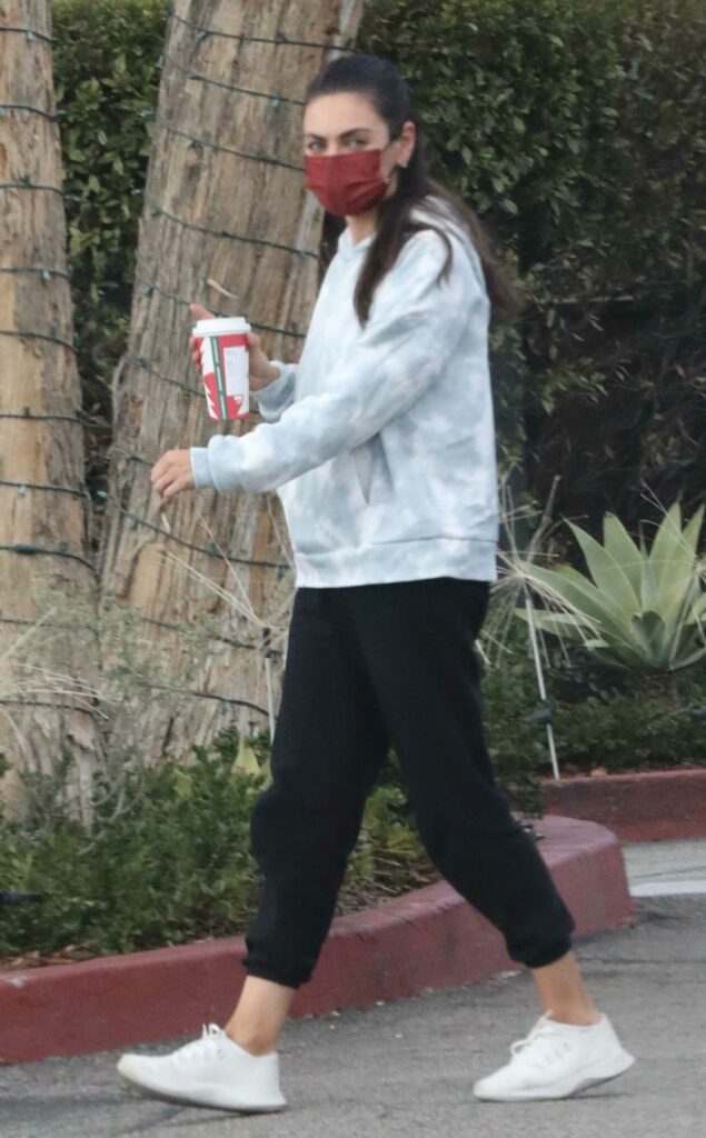 Mila Kunis in a Red Protective Mask