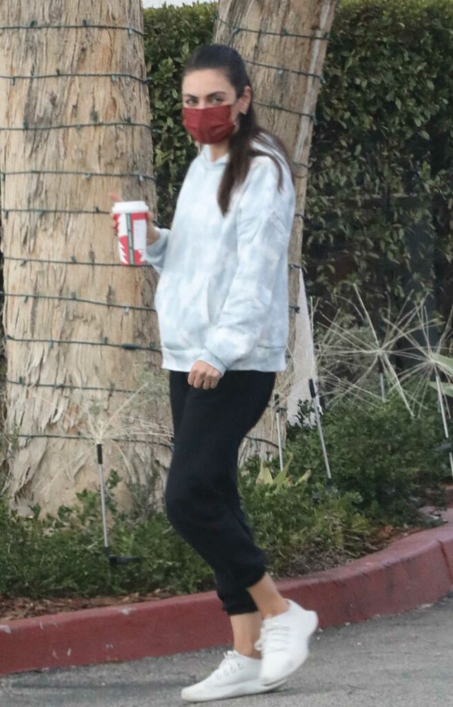 Mila Kunis in a Red Protective Mask