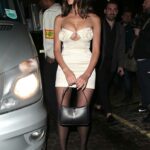 Olivia Culpo in a White Mini Dress Arrives at an After Party for 2022 Fashion Awards at Chiltern Firehouse in London