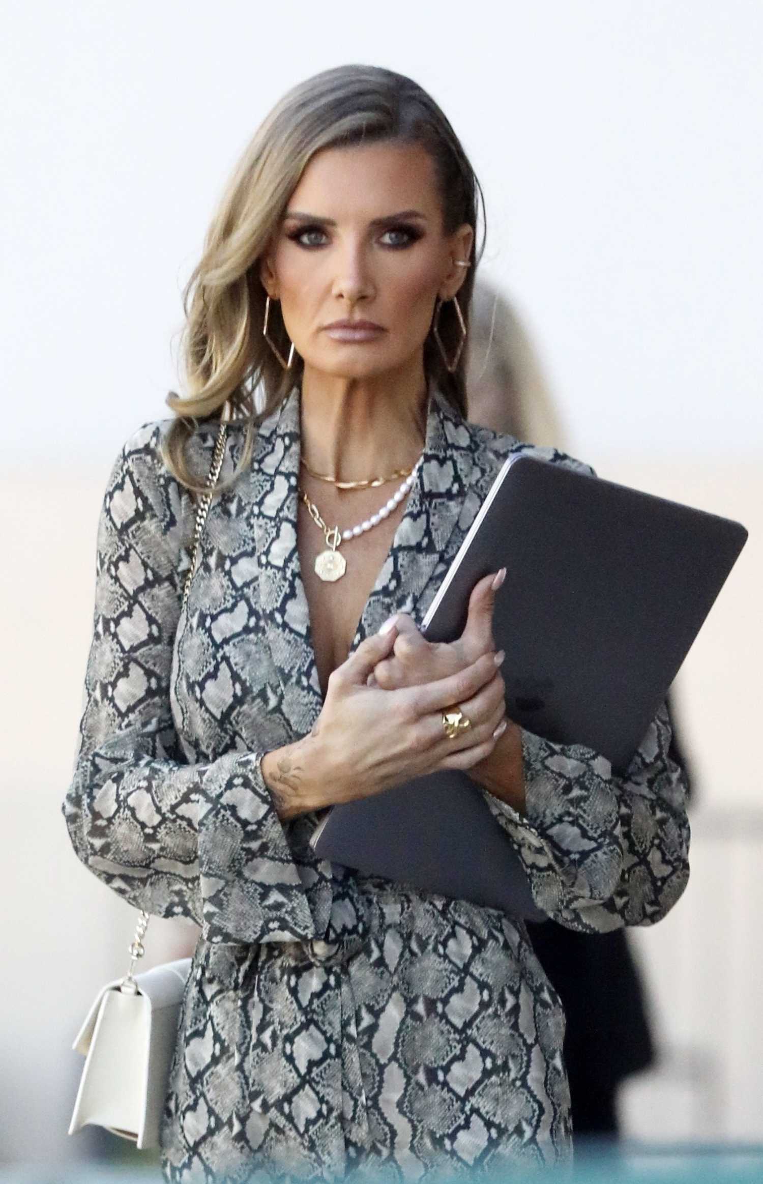 Nicole Young in a Grey Snakeskin Jumpsuit Was Seen Out in West