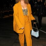 Ella Eyre in a Yellow Pantsuit Arrives at 2023 EE British Academy Film Awards Vanity Fair Rising Star BAFTAs Pre-Party in London