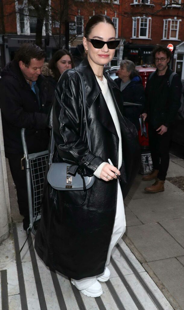 Lily James in a Black Leather Coat