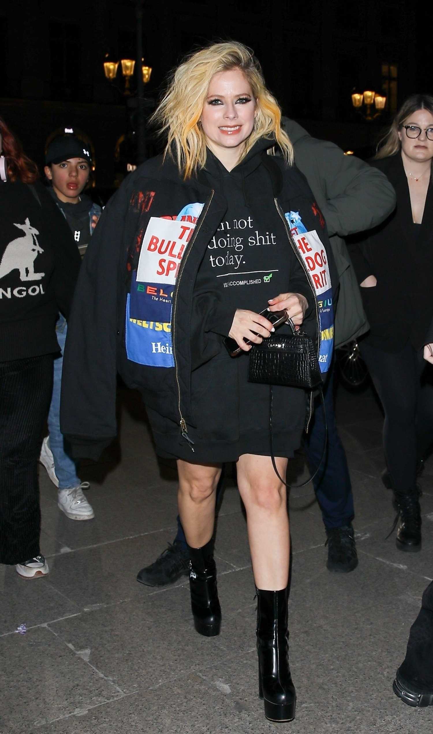 Avril Lavigne in a Black Oversized Hoodie Leaves the Ritz Hotel in