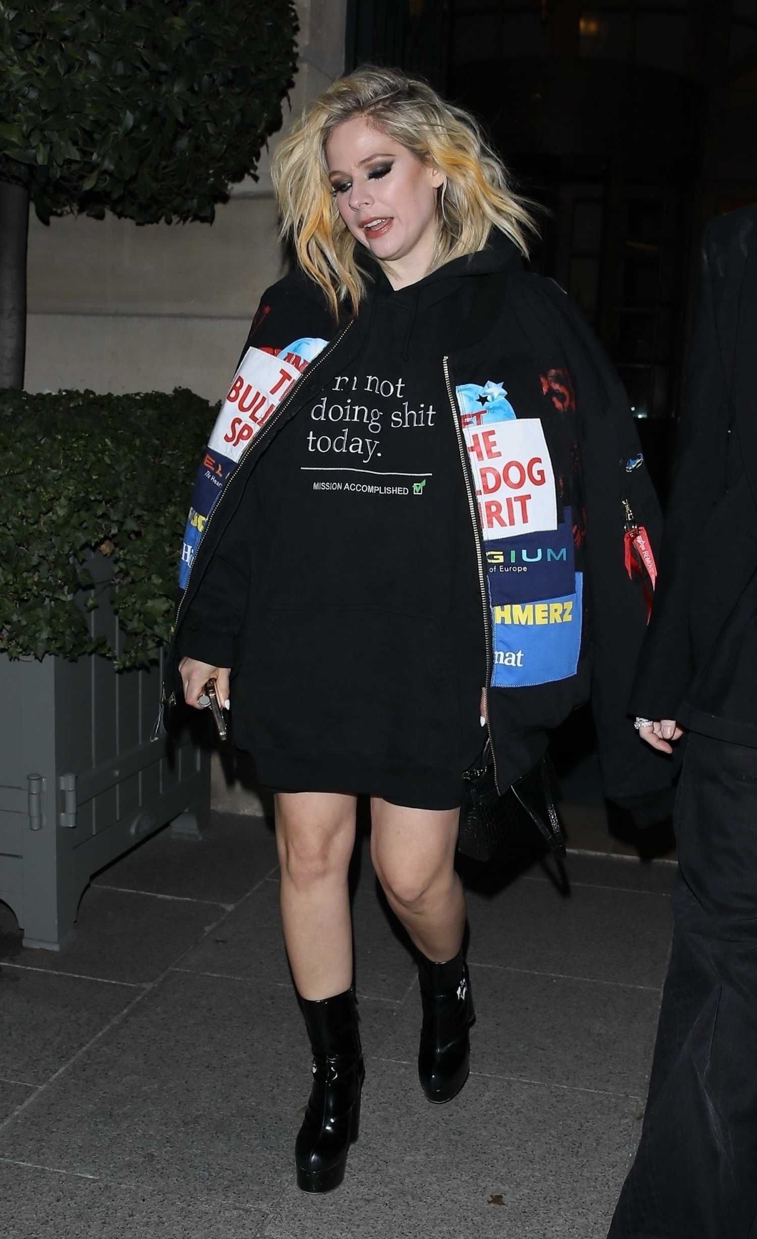 Avril Lavigne in a Black Oversized Hoodie Leaves the Ritz Hotel in