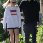 Dakota Fanning in a Black Spandex Shorts Was Spotted Keeping Close to White Lotus Producer David Bernard in Los Angeles