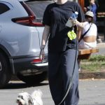 Noah Cyrus in a Black Tee Walks Her Dog in Los Angeles
