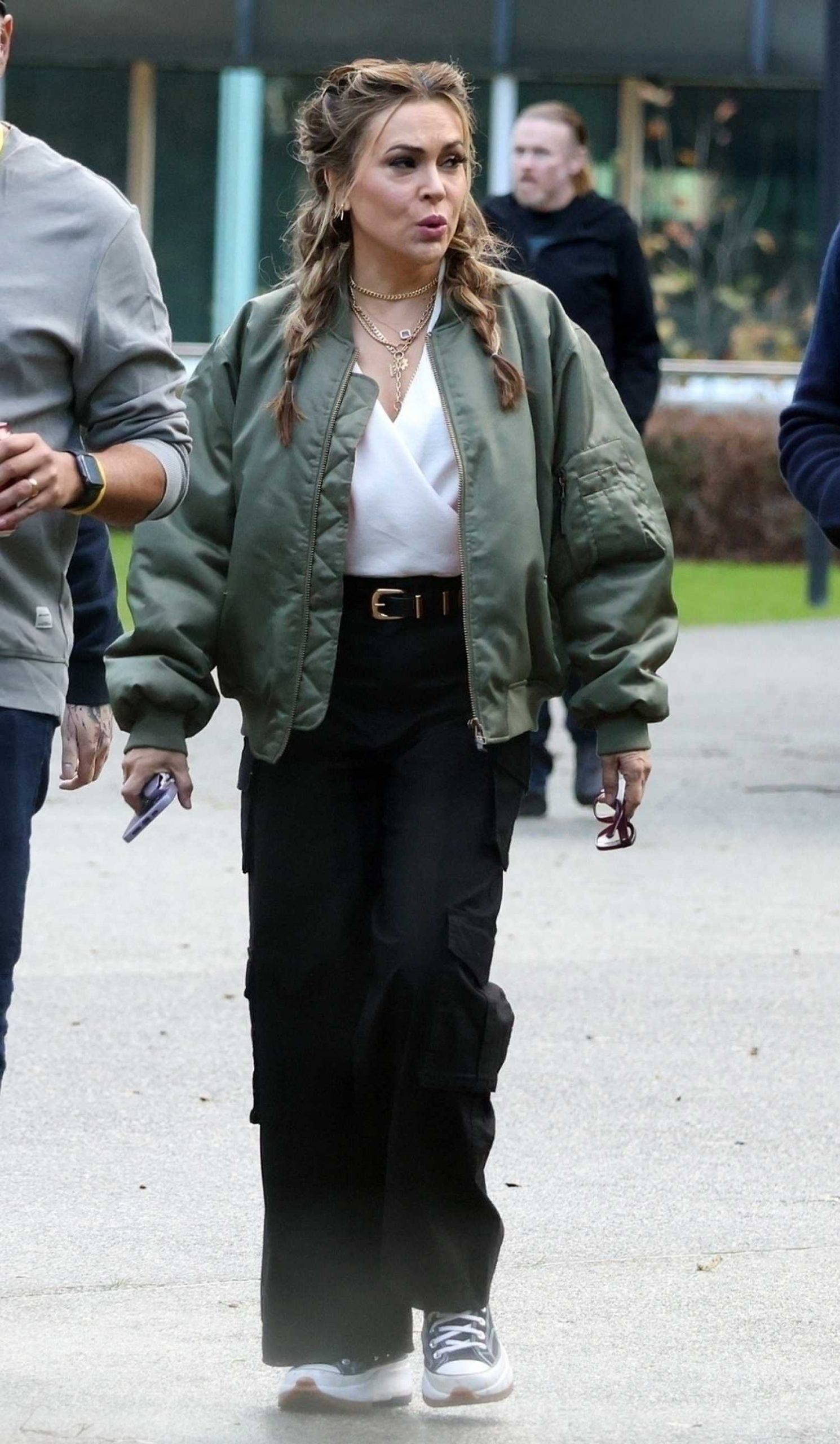 Alyssa Milano in an Olive Bomber Jacket Arrives at the Perth Convention