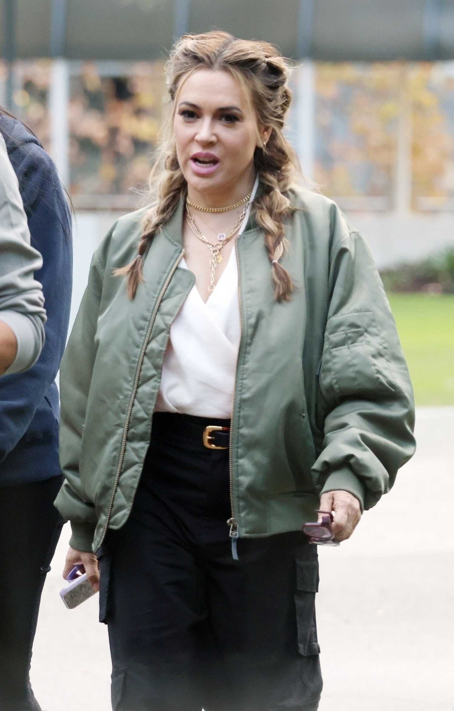 Alyssa Milano in an Olive Bomber Jacket Arrives at the Perth Convention