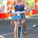 Amy Robach in a Blue Tank Top Rents a Citibike in New York