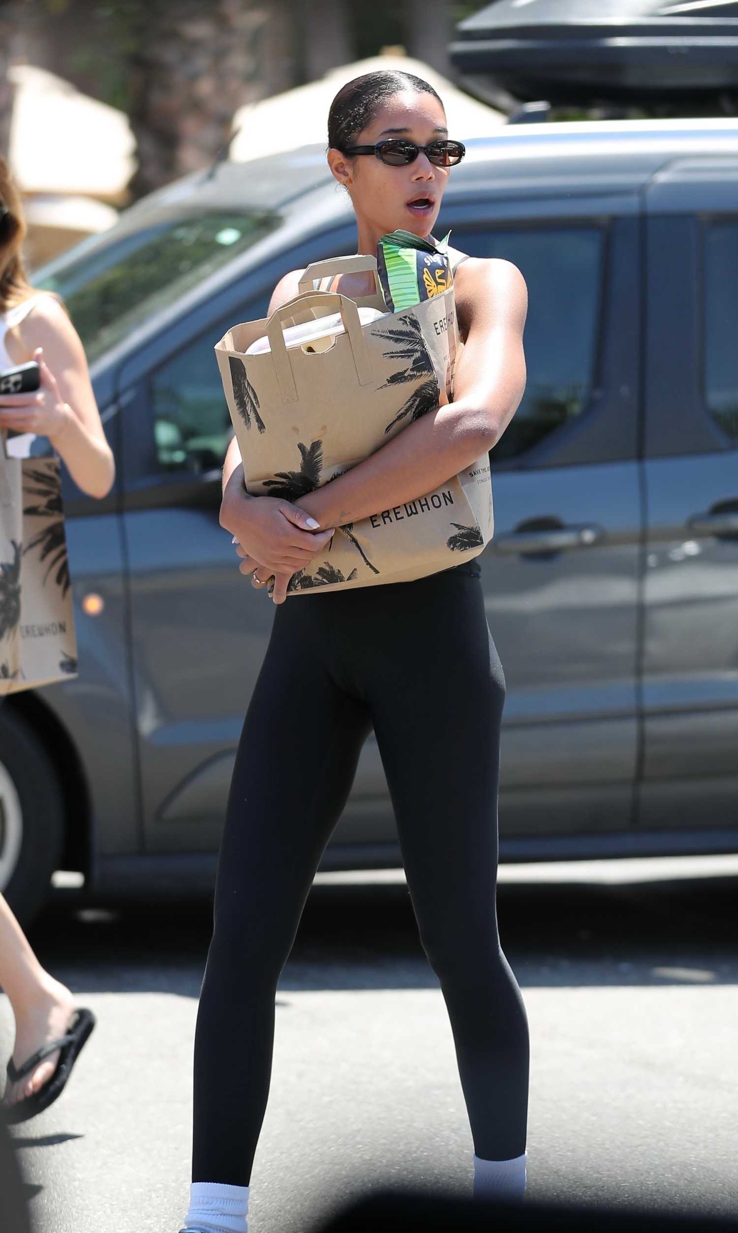 Laura Harrier in a Black Leggings Brings a Friend Along for Some ...