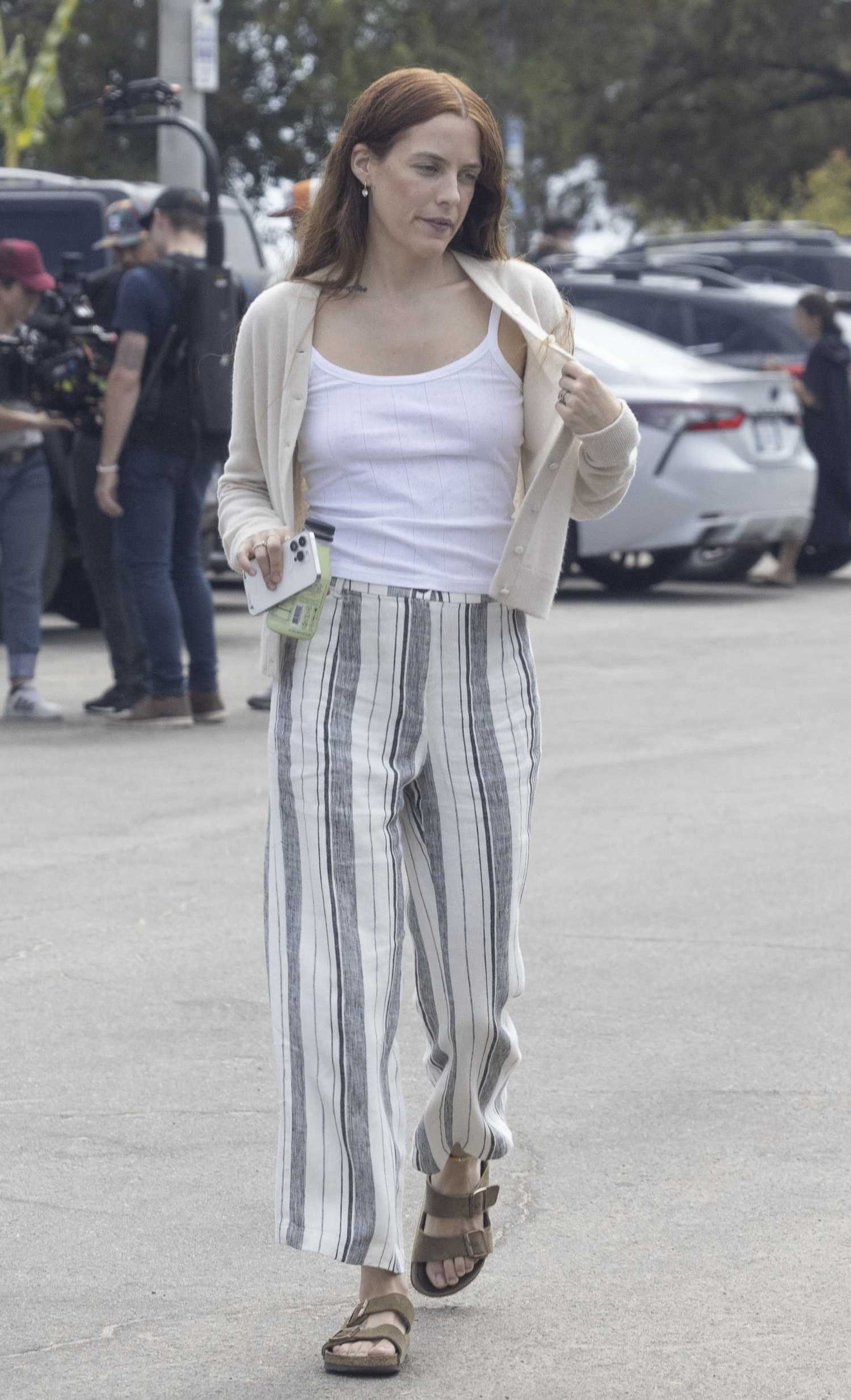 Riley Keough in a Beige Cardigan Filming a Commercial in Malibu – Celeb