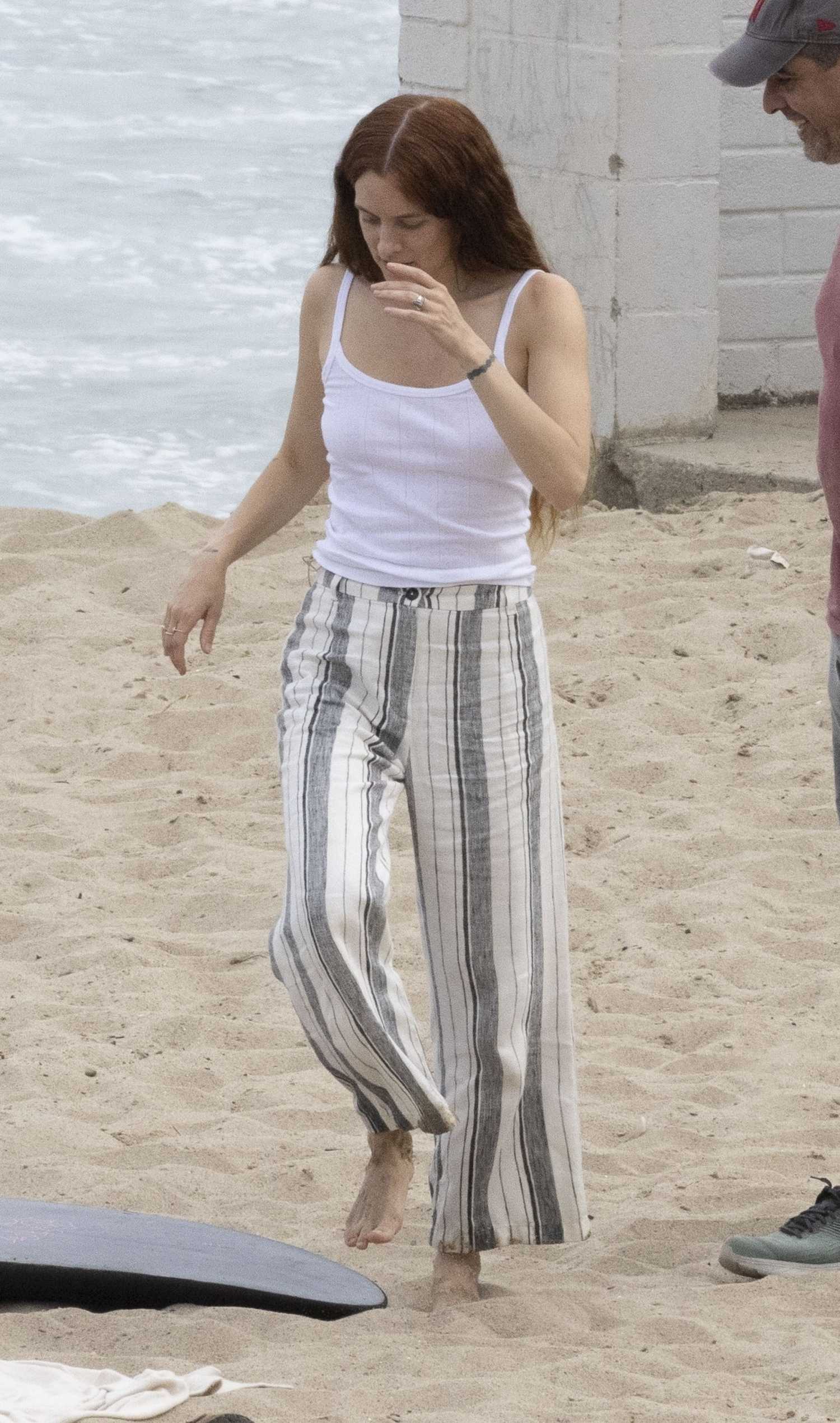Riley Keough in a Beige Cardigan Filming a Commercial in Malibu – Celeb