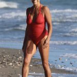 Jenny Powell in a Red Swimsuit on the Beach in Marbella