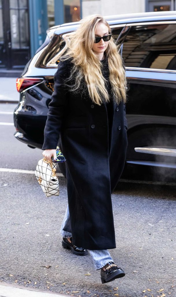 Sophie Turner in a Black Coat