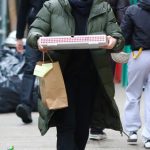 Dakota Fanning in an Olive Puffer Coat Grabs a Pizza to-go in New York City