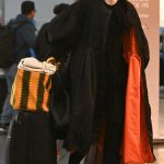 Gwendoline Christie in a Black Coat Arrives at JFK Airport in New York