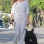 Gisele Bundchen in a White Blouse Was Spotted Taking Her Dog for a Stroll Through Miami