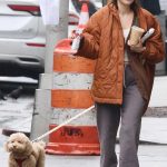 Millie Bobby Brown in a Black Adidas Sneakers Walks Her Dog in New York City