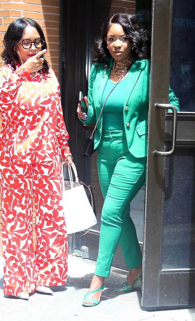 Jasmine Crockett in a Green Pantsuit