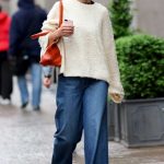 Katie Holmes in a Beige Sweater Braves the Rain in New York