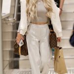 Jessika Power in a Beige Top Arrives Back in Brisbane