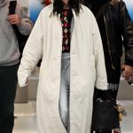 Dua Lipa in a White Coat Arrives at JFK Airport in New York City