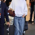 Charlize Theron in a White Sweatshirt Arrives in Sydney