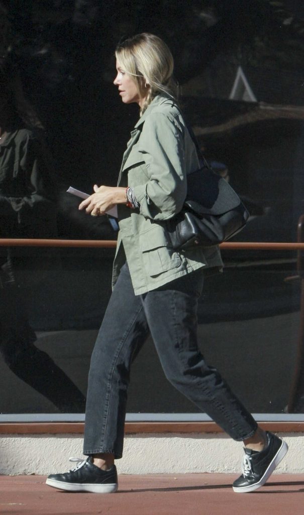 Christine Baumgartner in an Olive Jacket