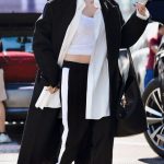 Dove Cameron in a Black Coat Arrives at LAX Airport in LA
