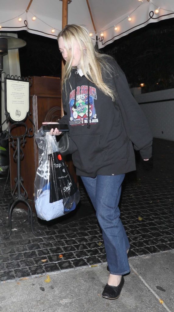 Dakota Fanning in a Black Hoodie