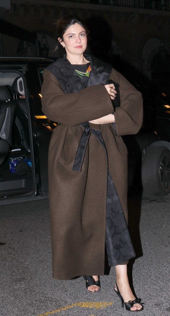 Monica Barbaro in a Brown Coat