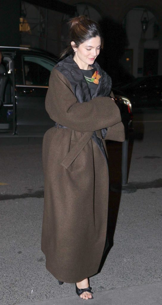 Monica Barbaro in a Brown Coat