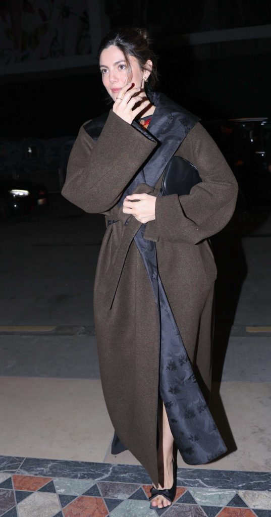Monica Barbaro in a Brown Coat