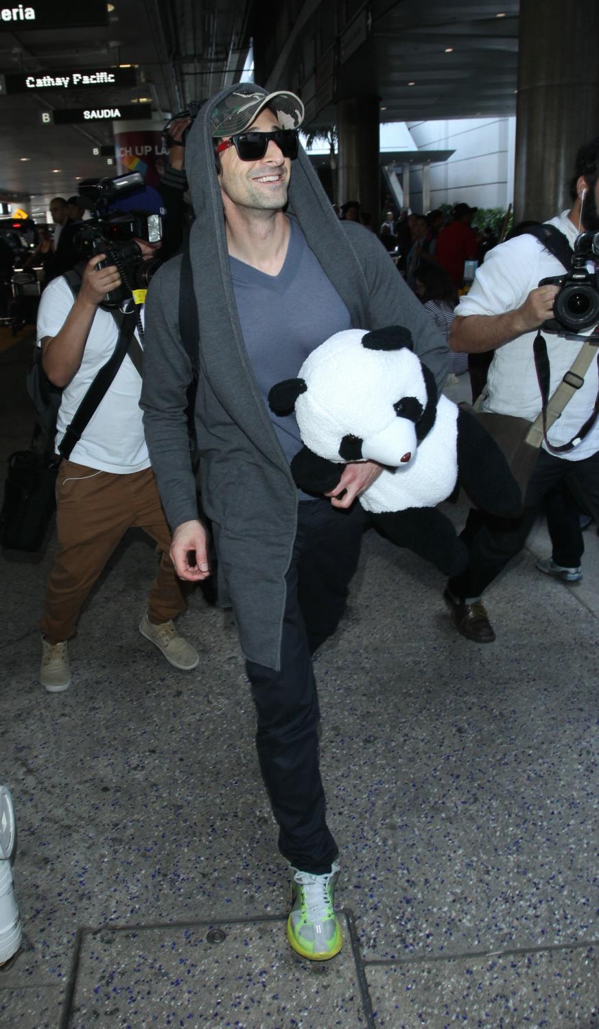 Adrien Brody Holding Panda Arrives at LAX Airport