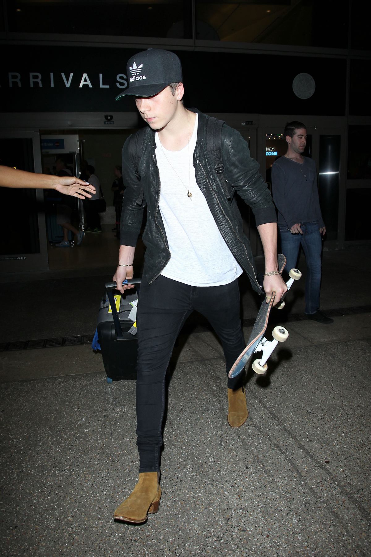 Brooklyn Beckham Arrives at LAX Airport with Skateboard