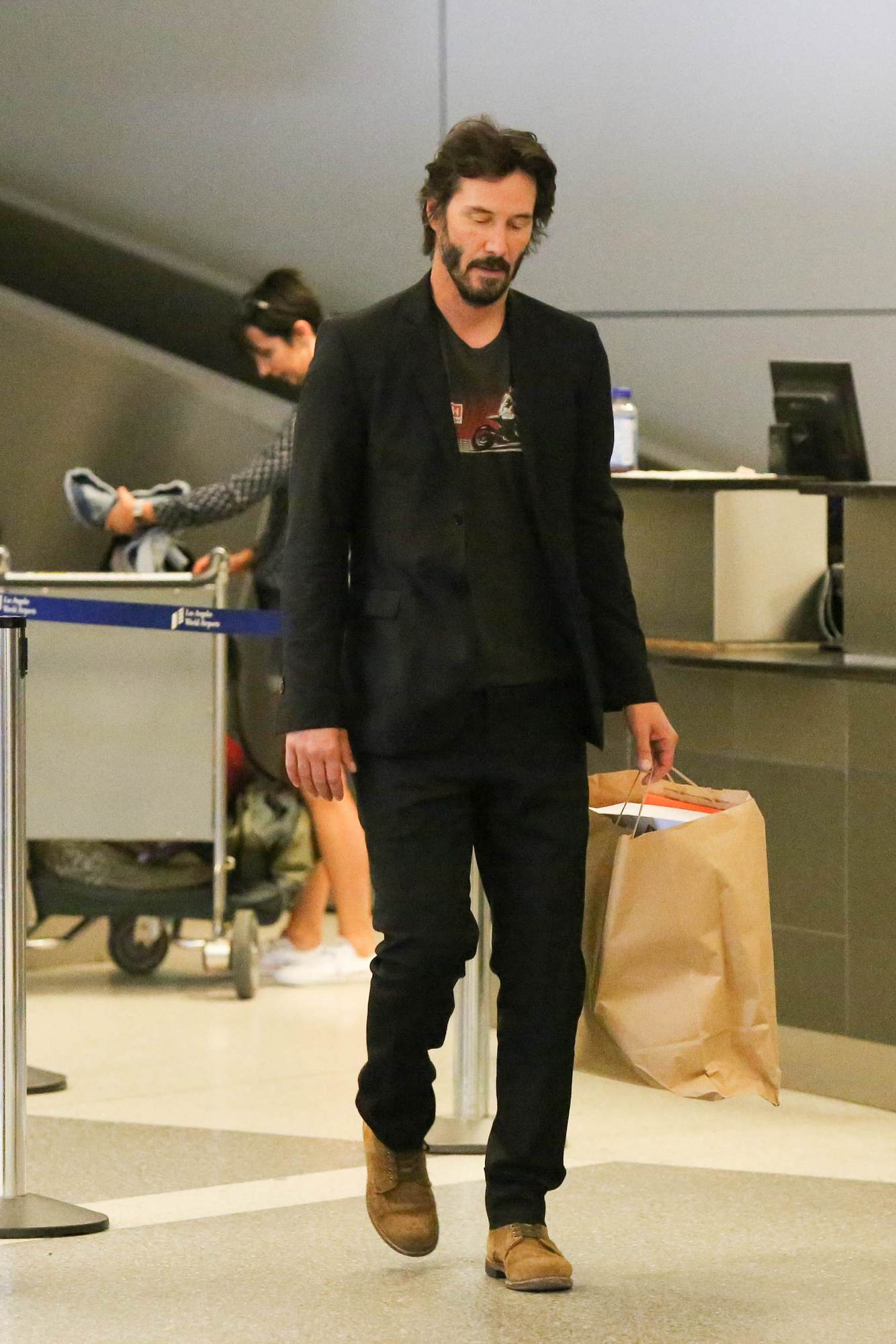 Keanu Reeves Looking Bored As He Arrives at LAX