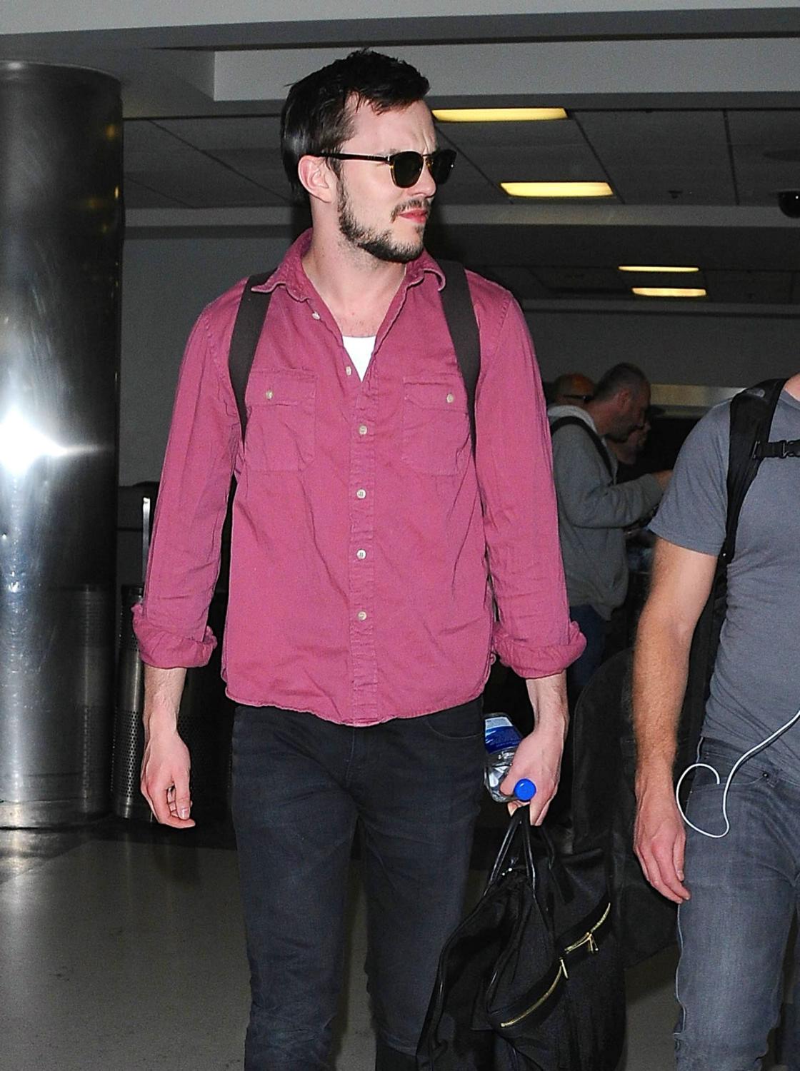 Nicholas Hoult arriving on a flight at LAX